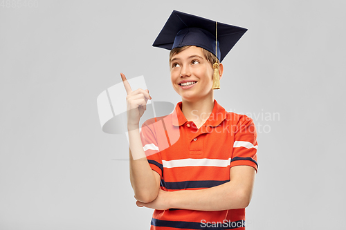 Image of graduate student boy in mortarboard with finger up