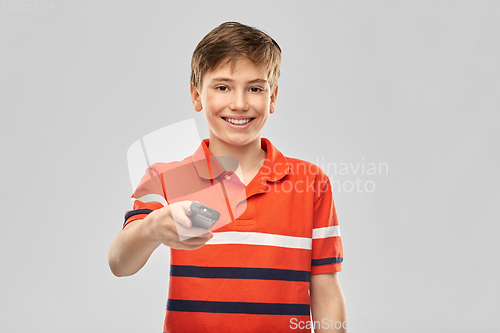 Image of smiling boy with tv remote control