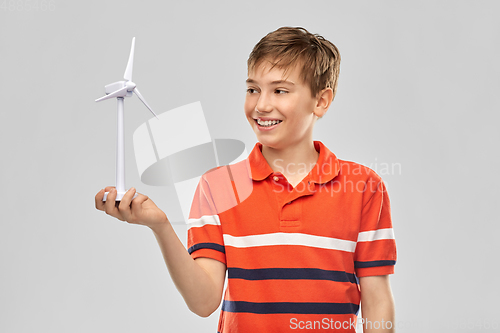 Image of happy smiling boy holding toy wind turbine