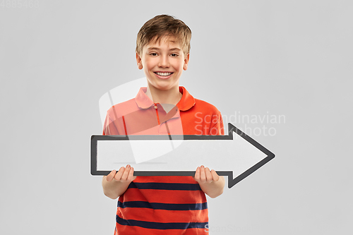 Image of happy boy holding big white rightwards thick arrow