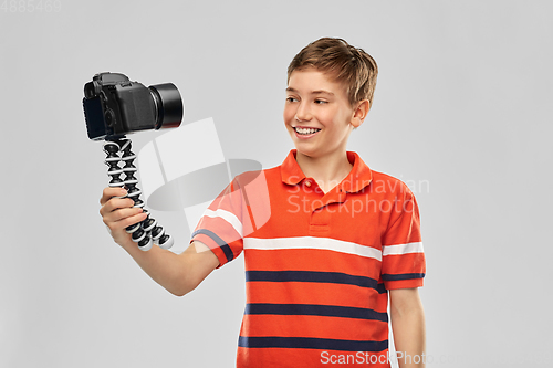 Image of boy video blogger with camera and tripod