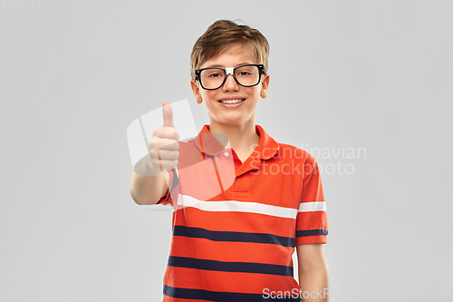 Image of happy smiling boy in eyeglasses showing thumbs up