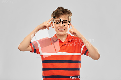 Image of portrait of happy smiling boy in crooked glasses