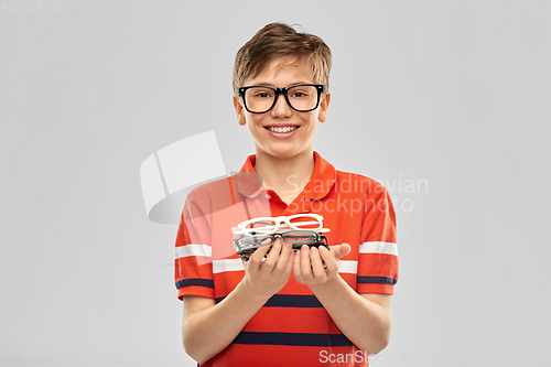 Image of portrait of happy smiling boy with eyeglasses