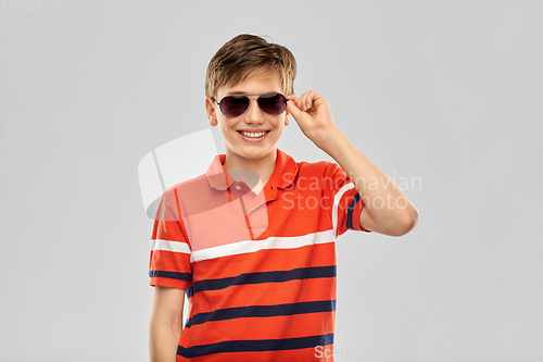 Image of portrait of happy smiling boy in sunglasses