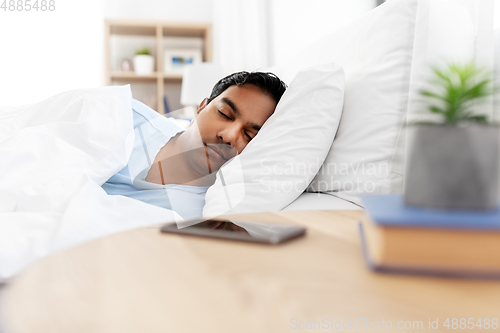 Image of indian man sleeping in bed at home