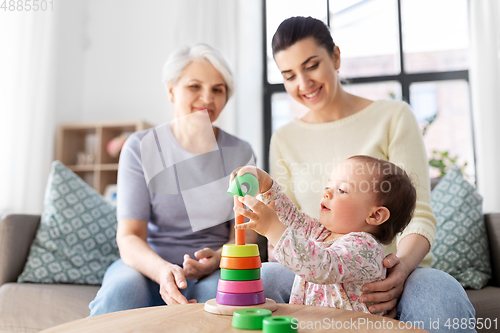 Image of mother, baby daughter and granny playing at home