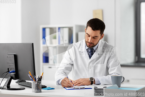 Image of male doctor with clipboard at hospital