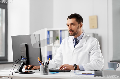 Image of male doctor with computer working at hospital