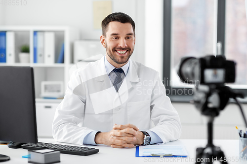 Image of male doctor recording video blog at hospital