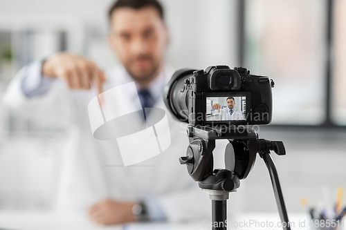 Image of male doctor recording video blog at hospital