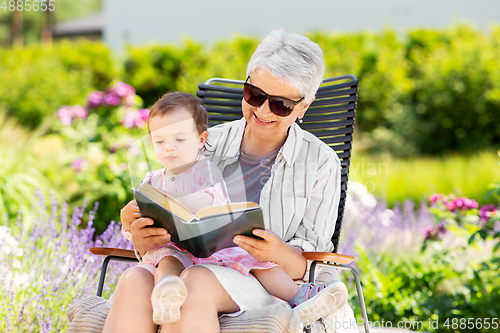 Image of grandmother and baby granddaughter reading book