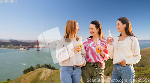 Image of young women with drinks talking in san francisco