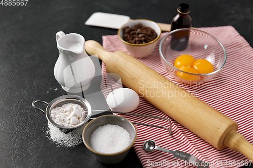 Image of rolling pin, milk, eggs, flour and chocolate