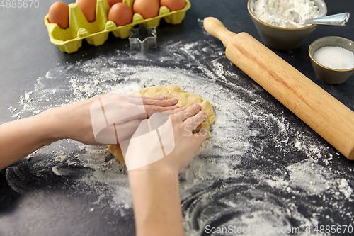 Image of hands making shortcrust pastry dough on table