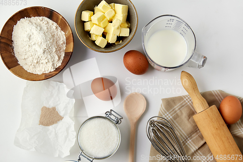 Image of rolling pin, butter, eggs, flour, milk and sugar