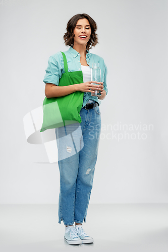 Image of woman with bag for food shopping and glass bottle