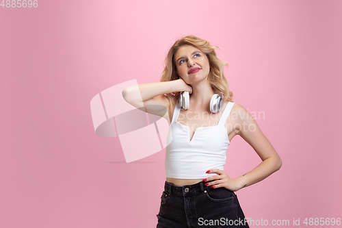 Image of Caucasian young woman\'s portrait isolated on pink studio background. Beautiful female model. Concept of human emotions, facial expression, sales, ad, youth culture.