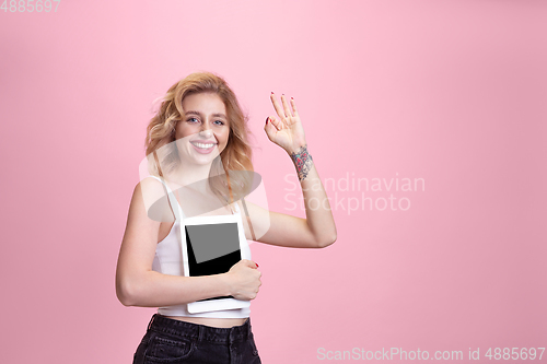 Image of Caucasian young woman\'s portrait isolated on pink studio background. Beautiful female model. Concept of human emotions, facial expression, sales, ad, youth culture.