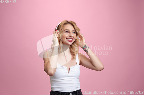 Image of Caucasian young woman\'s portrait isolated on pink studio background. Beautiful female model. Concept of human emotions, facial expression, sales, ad, youth culture.