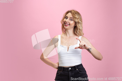 Image of Caucasian young woman\'s portrait isolated on pink studio background. Beautiful female model. Concept of human emotions, facial expression, sales, ad, youth culture.