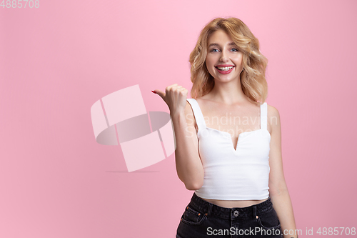 Image of Caucasian young woman\'s portrait isolated on pink studio background. Beautiful female model. Concept of human emotions, facial expression, sales, ad, youth culture.