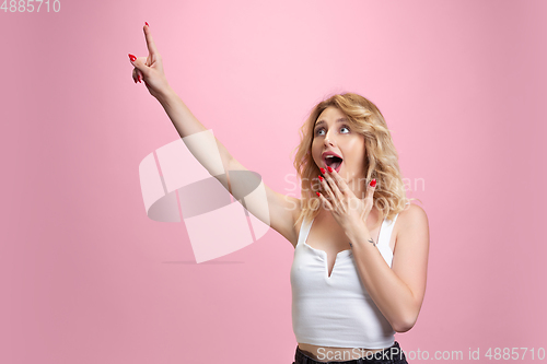 Image of Caucasian young woman\'s portrait isolated on pink studio background. Beautiful female model. Concept of human emotions, facial expression, sales, ad, youth culture.