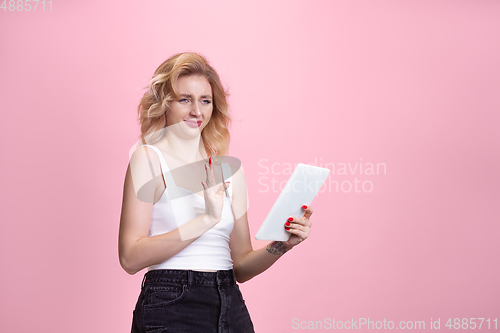 Image of Caucasian young woman\'s portrait isolated on pink studio background. Beautiful female model. Concept of human emotions, facial expression, sales, ad, youth culture.