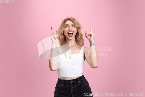 Image of Caucasian young woman\'s portrait isolated on pink studio background. Beautiful female model. Concept of human emotions, facial expression, sales, ad, youth culture.