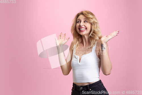 Image of Caucasian young woman\'s portrait isolated on pink studio background. Beautiful female model. Concept of human emotions, facial expression, sales, ad, youth culture.