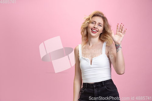 Image of Caucasian young woman\'s portrait isolated on pink studio background. Beautiful female model. Concept of human emotions, facial expression, sales, ad, youth culture.