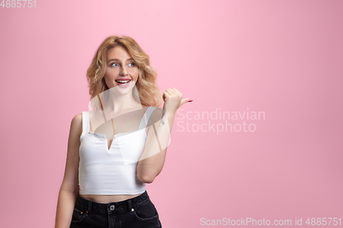 Image of Caucasian young woman\'s portrait isolated on pink studio background. Beautiful female model. Concept of human emotions, facial expression, sales, ad, youth culture.