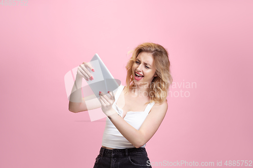 Image of Caucasian young woman\'s portrait isolated on pink studio background. Beautiful female model. Concept of human emotions, facial expression, sales, ad, youth culture.