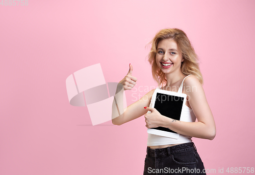 Image of Caucasian young woman\'s portrait isolated on pink studio background. Beautiful female model. Concept of human emotions, facial expression, sales, ad, youth culture.