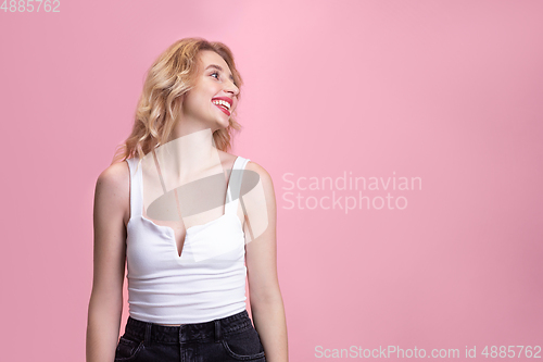 Image of Caucasian young woman\'s portrait isolated on pink studio background. Beautiful female model. Concept of human emotions, facial expression, sales, ad, youth culture.