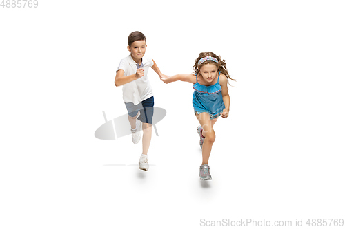 Image of Happy little caucasian girl and boy jumping and running isolated on white background