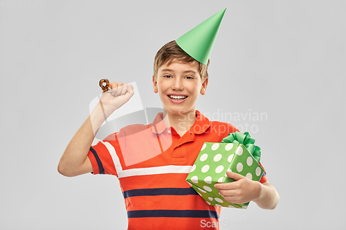 Image of happy boy in party hat with birthday gift box