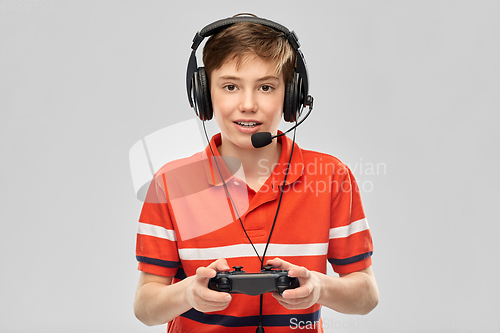 Image of boy in headphones with gamepad playing video game