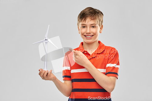 Image of happy smiling boy holding toy wind turbine