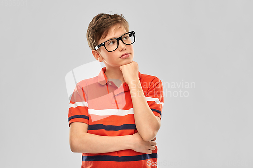 Image of portrait of thinking boy in eyeglasses