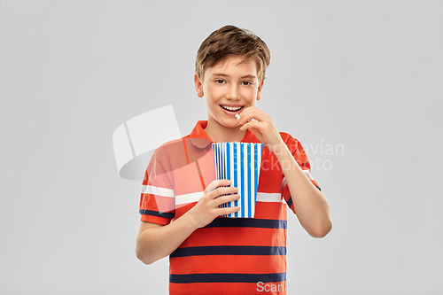 Image of smiling boy eating popcorn