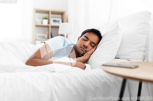 Image of indian man sleeping in bed at home