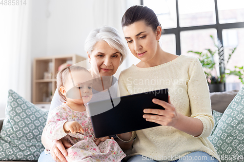 Image of mother, daughter and grandma with tablet pc