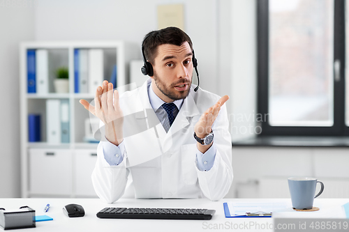 Image of doctor with headset having video call at hospital