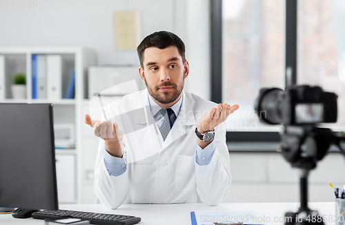 Image of male doctor recording video blog at hospital