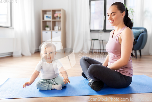 Image of happy mother with little baby at home