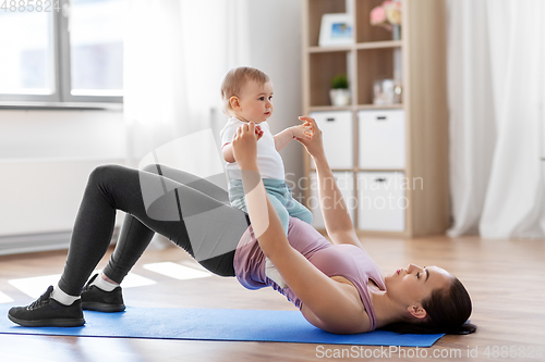 Image of mother with little baby exercising at home