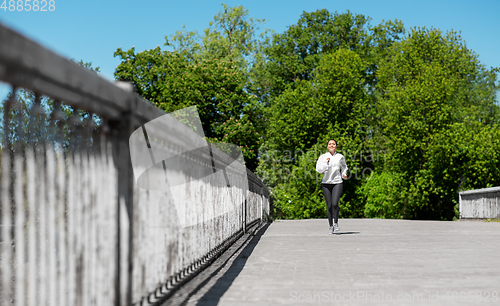 Image of african american woman running outdoors