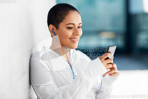 Image of african american woman with earphones and phone