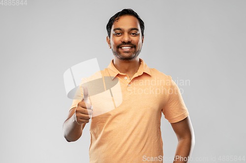 Image of portrait of happy indian man showing thumbs up